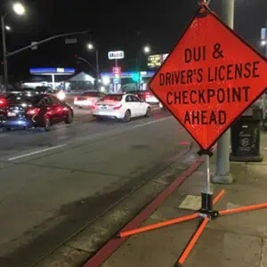 A sign warning of a DUI and drivers license checkpoint ahead. DWI/DUI Investigation