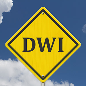 Yellow diamond road sign with DWI text, warning about Drunk Driving laws and criminal defense.