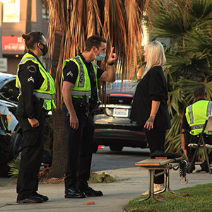 Police officers conducting a Field Sobriety Test on a woman, illustrating a DWI defense strategy or challenge