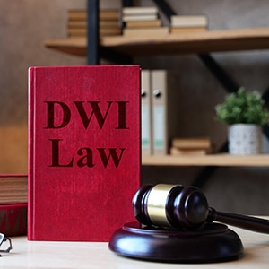 Red book titled DWI Law next to a gavel, representing Orange County DWI Defense in New York criminal law